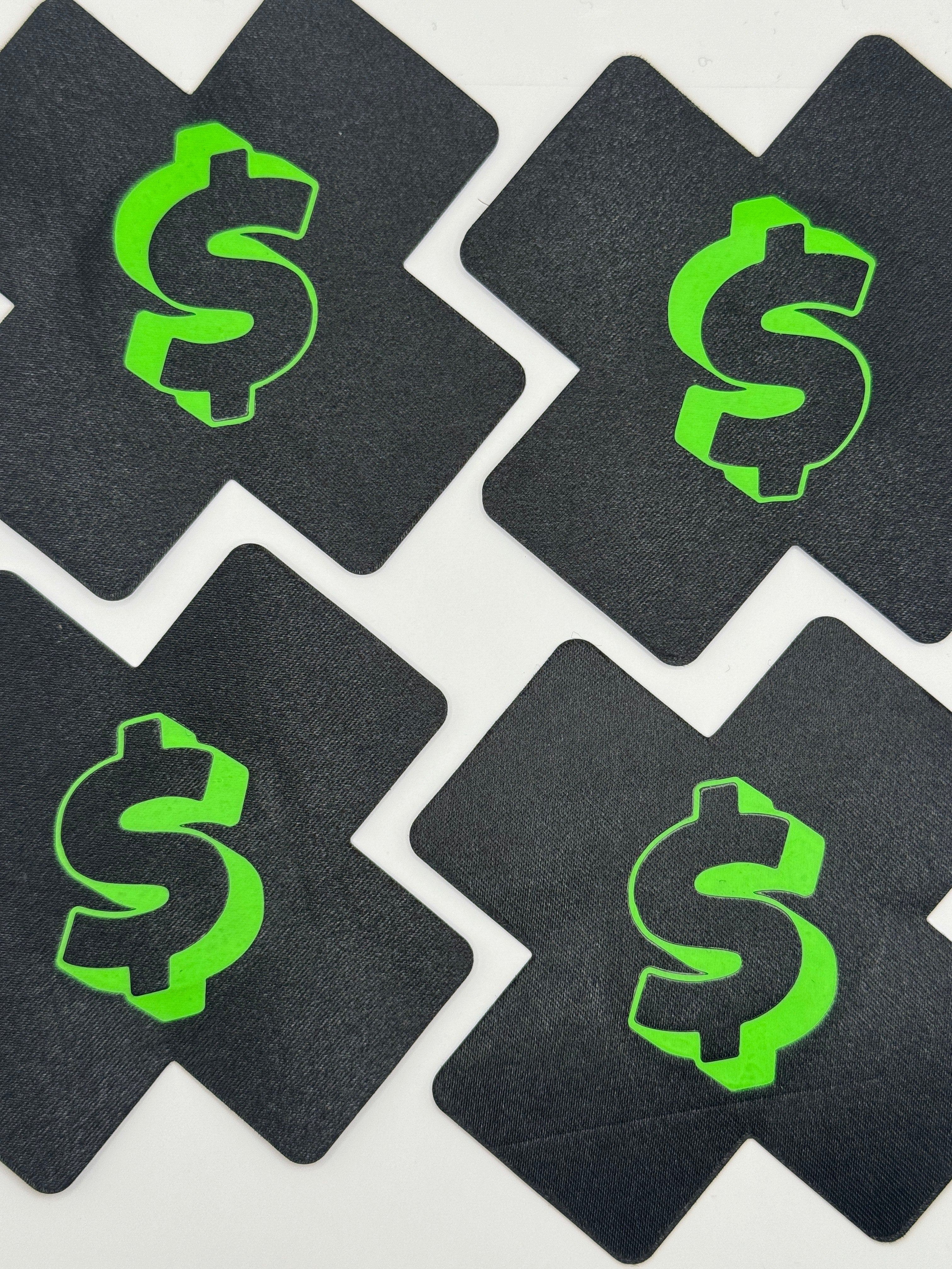 Black coasters with green dollar sign design on a white background